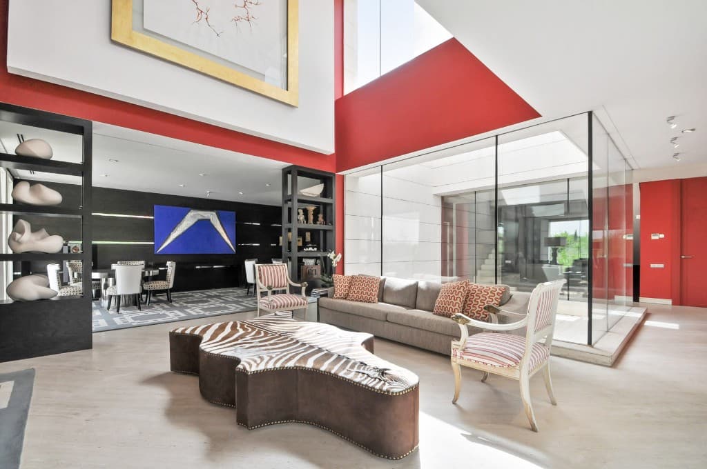 Still photo of a modern living room with a red feature wall